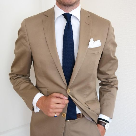 Tan suit with navy tie